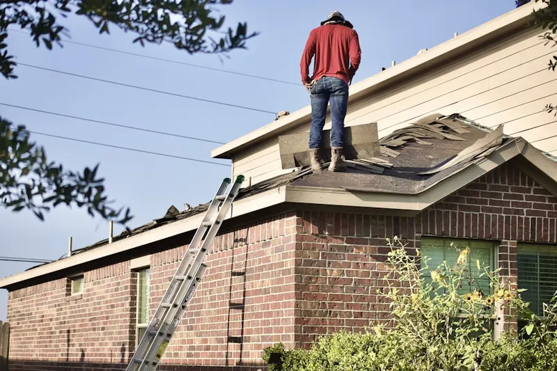 Professional roofer working on a residential roof in Tehaleh